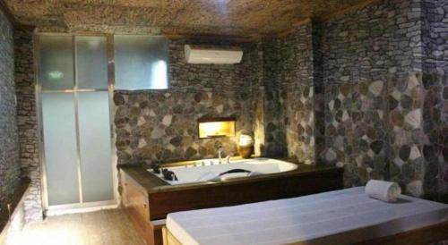 a bathroom with a bath tub and a sink at Anda de Boracay in Bohol Hotel in Anda