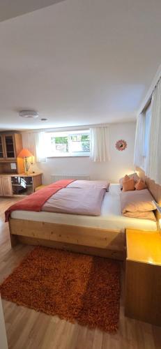 a large bed in a bedroom with a window at Apartment Hausberger in Mayrhofen