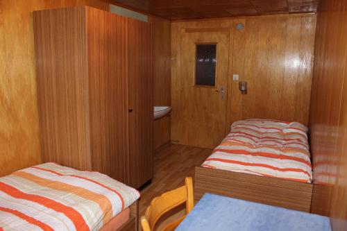 a small room with two beds and a table at Mittaghornblick in Saas-Grund