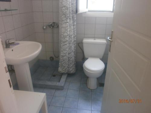 a bathroom with a toilet and a sink at Anastasia Apartments in Korissia