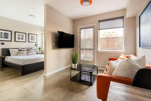 a living room with a couch and a bed at Stay Portland - Bright Studio Apartment - Food Carts & Local Shops in Portland