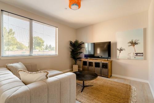 a living room with a couch and a flat screen tv at Stay Portland - Modern Home in Foodie District - 2BR - Sleeps 4 in Portland
