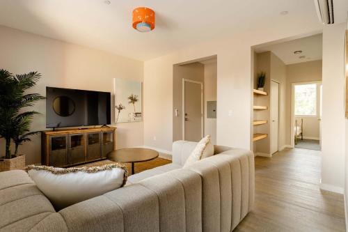 a living room with a couch and a tv at Stay Portland - Modern Home in Foodie District - 2BR - Sleeps 4 in Portland