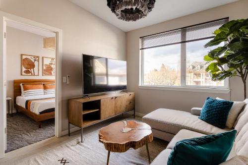 a living room with a couch and a tv at Stylish Portland 1BR w 90 WalkScore in Portland