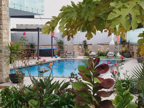 a swimming pool in a garden with plants at Villa Luz 37 - Jacuzzi Terrace & Swimming Pool in Albufeira