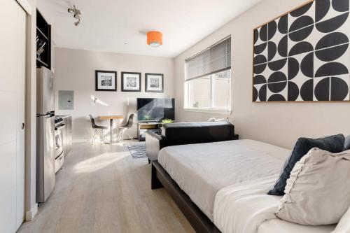 a bedroom with a bed and a couch in it at Stay Portland - Modern Portland Studio - Food Carts & Local Shops in Portland