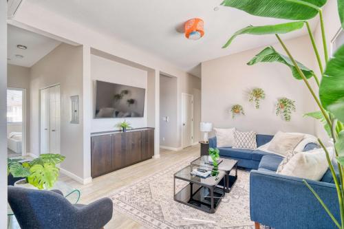 a living room with a blue couch and a table at Portland Penthouse Retreat- Roof Deck & Food Pods in Portland