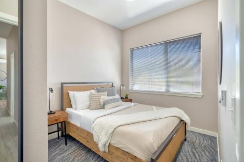 a bedroom with a bed and a window at Portland Penthouse Retreat- Roof Deck & Food Pods in Portland