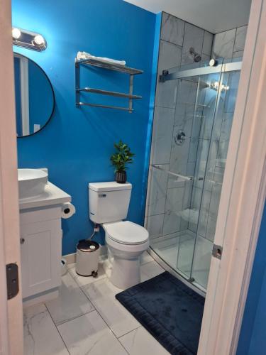 a bathroom with a toilet and a glass shower at Work & Lake Guest house at Airport in SeaTac