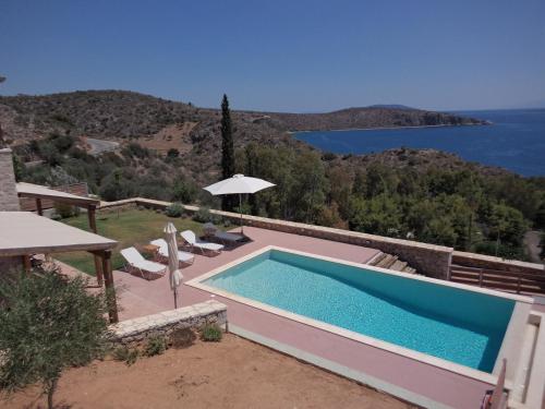 a swimming pool with a view of the water at Lefka's Villas in Vivari