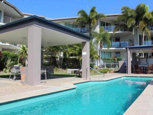 a swimming pool in front of a building at Caloundra Central Apartment Hotel Official in Caloundra