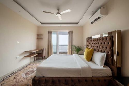 a bedroom with a large bed and a desk at Villa Avanora by DanCenter in Arpora