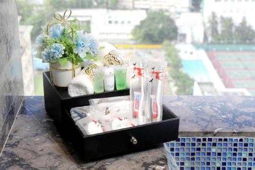 a black box with toothbrushes and other products on a table at Elysion Place Hotel Causeway Bay in Hong Kong