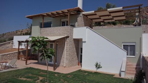 a villa with a view of a house at Lefka's Villas in Vivari