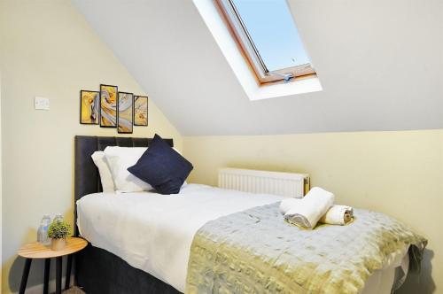 a bedroom with a large bed and a window at King Size beds, CCTV parking , Discounts in Shinfield