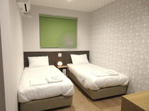 Postel nebo postele na pokoji v ubytování RJ HOTELS OTARU