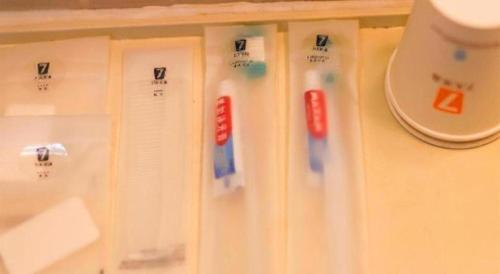 a white refrigerator with magnets on a wall at 7 Days Premium·Tianjin Gulou Metro Station Joy City in Tianjin