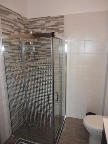 a shower stall in a bathroom with a toilet at Lefka's Villas in Vivari