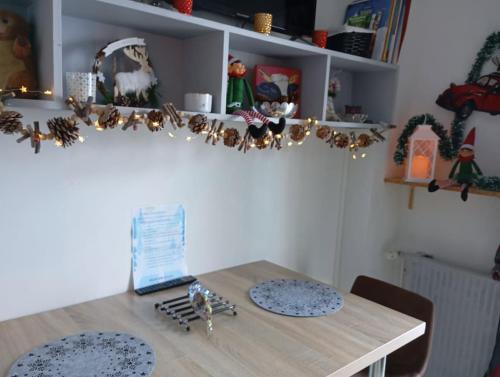 a table with two plates and a laptop on it at Petit studio lumineux vue montagne in La Mongie