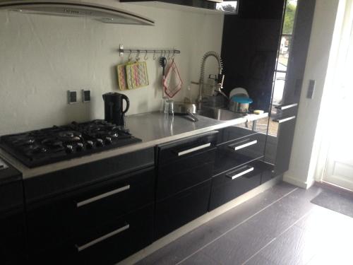 a kitchen with a stove and a counter top at Rane Ladegaard in Ebeltoft
