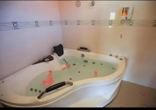 a bath tub in a corner of a room at Ngamta Hotel in Mae Hong Son