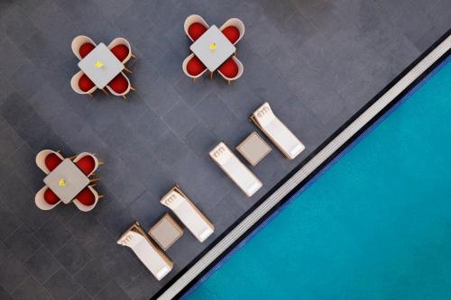 an overhead view of tables and chairs in a cafeteria at Crowne Plaza Lucknow by IHG in Lucknow