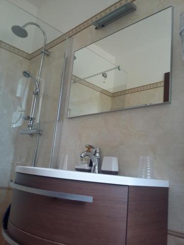 a bathroom with a sink and a mirror at B&B Itufi in Colonnella