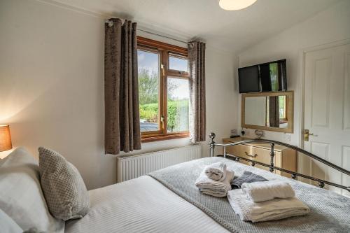 a bedroom with a bed with towels on it at Lakeview Lodge in Carnforth