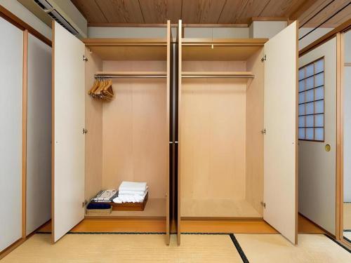 a walk in closet with a sliding door at New Biwako Hotel in Zeze-Awazumachi