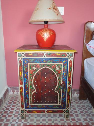 a table with a lamp on top of it at Dar Yanis in Rabat