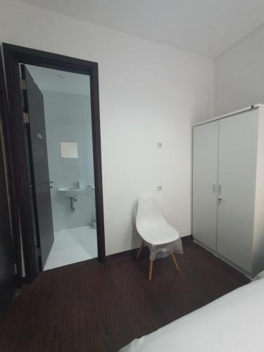a room with a mirror and a chair and a sink at The Breakout Room ICE BSD in Serpong