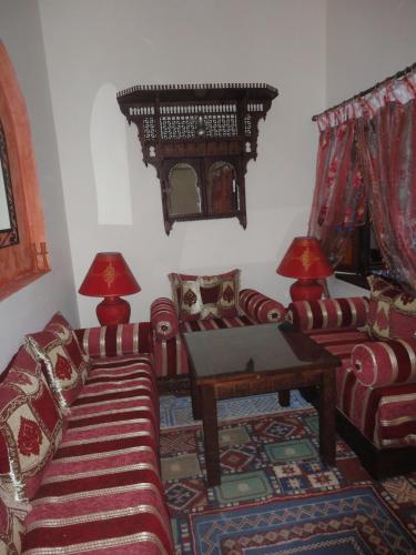 a living room with two couches and a table at Dar Yanis in Rabat