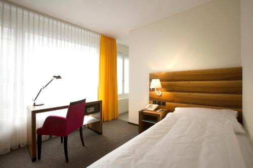 מיטה או מיטות בחדר ב-Hotel Astoria