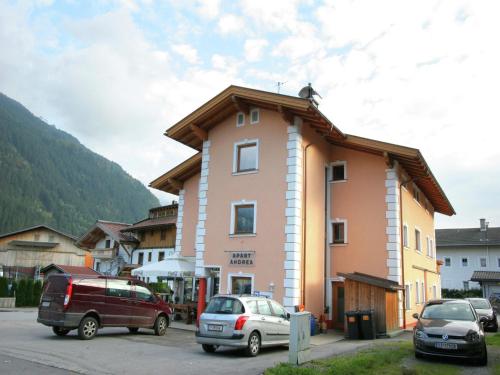 a building with cars parked in a parking lot at Spacious Apartment in Uderns near Ski Area in Uderns