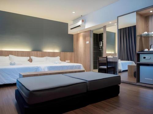 a hotel room with a large bed and a desk at Mornington Hotel Medan Ipoh in Kampong Simee