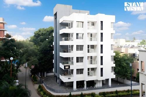 an architectural rendering of a white apartment building at StayVista Residences at Baner - Balewadi with Purifier in Pune