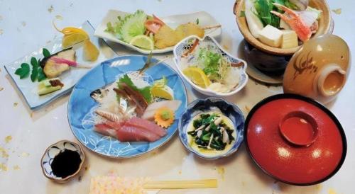 a group of plates of food on a table at AKISAWA HOTEL in Sukumo