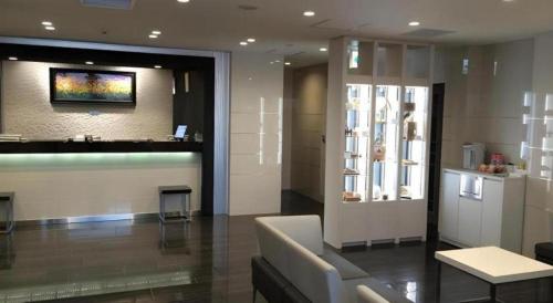 a lobby of a building with a counter and a window at JR-EAST HOTEL METS NAGAOKA in Nagaoka