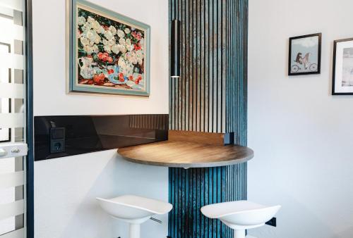 a wall mounted shower in a bathroom with two stools at SchönHier in Westerburg