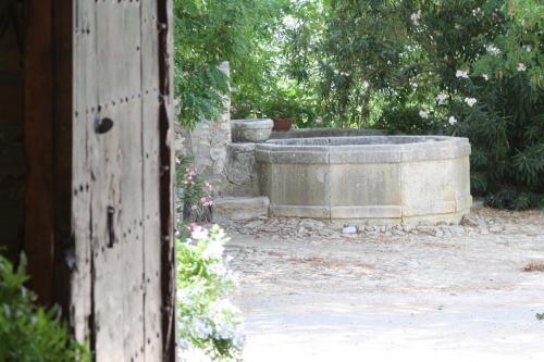 a large stone tub in a yard with trees at Agriturismo Ridocco in Corleone