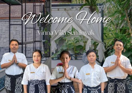 a group of people standing in aorative pose in front of a sign at Vinna Villa Seminyak in Kerobokan