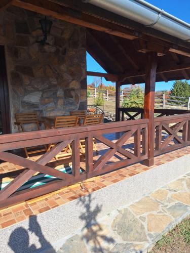 a wooden railing on a porch of a building at Planinska kuća Radulović in Goč