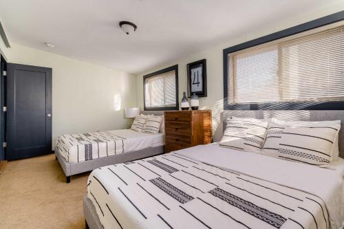 a bedroom with two beds and a window at Stay Portland - Portland Classic - Walk to Local Coffee & Food in Portland