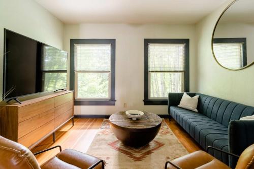 a living room with a couch and a tv at Stay Portland - Moab Vibes in PDX- Walk to Local Coffee & Food in Portland