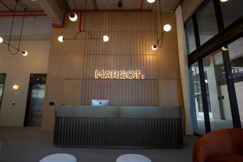 a sign on the wall of a marocott building at Margot Apartments By MrW in Guadalajara