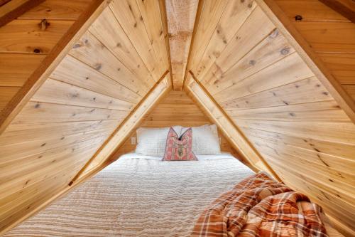 a room with a bed in a wooden house at Stay Portland - Tiny Log Cabin - Walk to Local Shops & Eateries in Portland