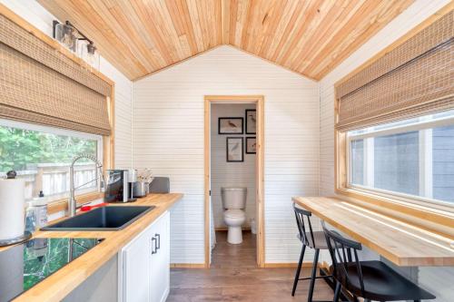 a kitchen with a sink and a toilet at Stay Portland - Tiny Farmhouse - Walk to Local Shops & Restaurants in Portland