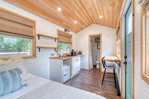 a tiny house with a kitchen and a bedroom at Stay Portland - Tiny Farmhouse - Walk to Local Shops & Restaurants in Portland