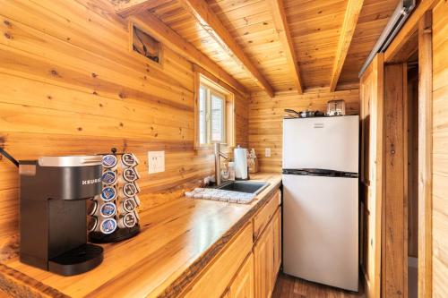 a kitchen with a refrigerator in a wooden cabin at Stay Portland - Tiny Log Cabin - Walk to Local Shops & Eateries in Portland