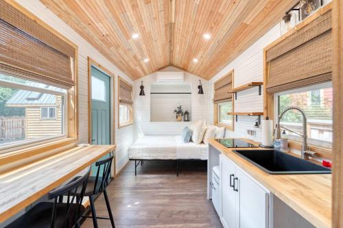 a kitchen with a sink in a tiny house at Stay Portland - Tiny Farmhouse - Walk to Local Shops & Restaurants in Portland